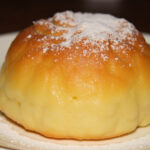 Finished Bolo de Aipim Cremoso Diferente, golden and creamy, ready to serve.