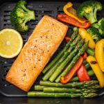Final presentation of air-fryer salmon steaks with vegetables, showcasing a healthy and appetizing meal.