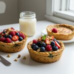 Delicious baked protein pancake bowls topped with fresh fruits and honey, served in a captivating presentation on a rustic wooden table.