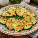 Beautifully presented Cheesy Garlic Zucchini Steaks with melted cheese, herbs, and vibrant colors, ideal for a delightful meal.
