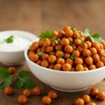 Delicious chili roasted chickpeas served in a bowl, garnished and ready to enjoy. Healthy snack recipe presentation.