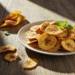 Delicious cinnamon-sugar air fryer banana chips served on a rustic plate, healthy and crispy snack display, mouthwatering presentation.
