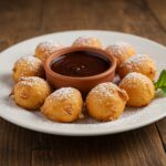 Final presentation of Crispy Deep Fried Marshmallows, featuring crispy texture and a side of chocolate sauce for dipping, highlighting the finished dessert.