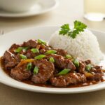 Delicious easy Chinese pepper steak served with rice, presenting a flavorful and colorful final dish ready to enjoy.