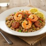 Delicious serving of Shrimp and Sausage Dirty Rice, artistically displayed on a wooden table, highlighting its vibrant colors and flavors.