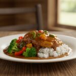 Delicious smothered chicken and rice dish served in an appealing way, perfect for family dinners.