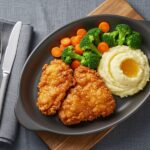 how to make the best crispy honey butter chicken, final serving of crispy honey butter chicken, gourmet fried chicken presentation, delicious chicken dinner with sides