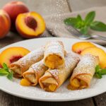 Delicious Peach Cobbler Egg Rolls served with mint and peaches, showcasing a perfect dessert presentation.