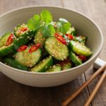 Final presentation of asiatic cucumber salad with chili and sesame, highlighting the freshness and vibrant colors that entice the senses.