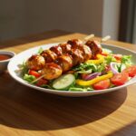 Deliciously presented BBQ chicken skewer salad filled with fresh greens, veggies, and savory chicken skewers for a healthy meal.
