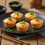 Delicious Baked Salmon Sushi Cups served on a plate, showcasing a vibrant and appetizing sushi dish ready to be enjoyed with dipping sauces.