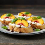 Gourmet peach bruschetta with whipped ricotta, a perfect appetizer showcasing fresh fruit and vibrant flavors.