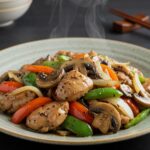 Deliciously plated Black Pepper Chicken with Mushrooms, highlighting succulent chicken, savory mushrooms, and vibrant vegetables in a beautifully presented dish.