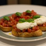 A delicious serving of Burrata Bruschetta with fresh tomatoes, basil, and creamy burrata cheese, beautifully plated for enjoyment.