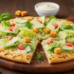 Final presentation of Caesar Salad Pizza, garnished with herbs and served with dressing, a perfect blend of flavors.