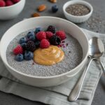 Delicious chia pudding with nut butter and fresh berries displayed in a bowl, an enticing healthy dessert or snack option.