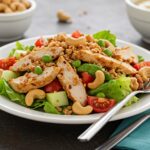 Delicious finished Chicken Cashew Crunch Salad close-up, highlighting fresh ingredients and crunchy cashews, perfect for a healthy meal.