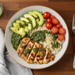 Final presentation of a chimichurri grilled chicken bowl with garlic sauce, a delicious and colorful meal ready to be enjoyed.