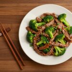 Deliciously plated Chinese Beef and Broccoli with vibrant colors, fresh ingredients, appealing presentation for a delightful meal.