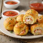 Golden brown crabby shrimp-stuffed garlic bread bombs served hot with marinara sauce, perfect for a savory appetizer