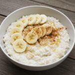 Delicious egg white oatmeal served in a bowl with banana and honey, perfect healthy breakfast display.