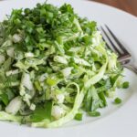 Final presentation of Green Goddess Cabbage Salad on a plate, highlighting the fresh ingredients and vibrant green dressing.