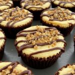 A stunning presentation of loaded brownie cheesecake cups, featuring rich layers of brownie and cheesecake, garnished with chocolate drizzle and nuts.