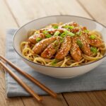 Final presentation of Quick and Flavorful Chicken Teriyaki Noodles, featuring garnishes and a visually appealing arrangement ready to be enjoyed.