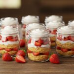 Delicious strawberry shortcake jars displayed elegantly on a table, perfect for dessert lovers looking for a fresh and tasty treat.