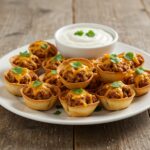 Final presentation of Taco Ranch Bites served on a plate with ranch dressing, perfect for parties or gatherings.