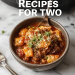 A cozy scene featuring a small, rustic crockpot filled with tender chicken and pasta, garnished with fresh herbs. The dish is beautifully plated on a wooden table with a side of colorful vegetables, steam gently rising, highlighting a warm and inviting presentation.